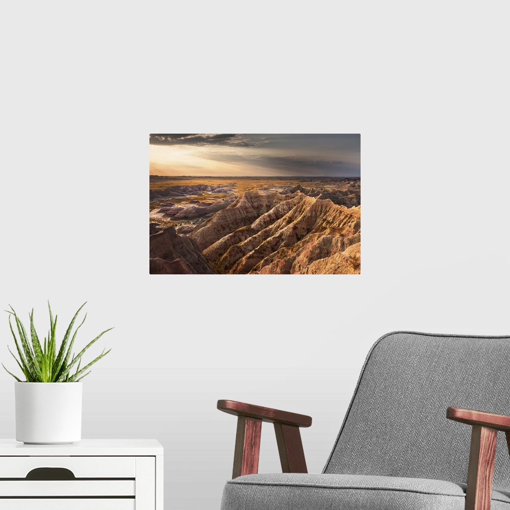 A modern room featuring Beams of sunlight shining on the rugged landscape of the South Dakota Badlands in the morning.
