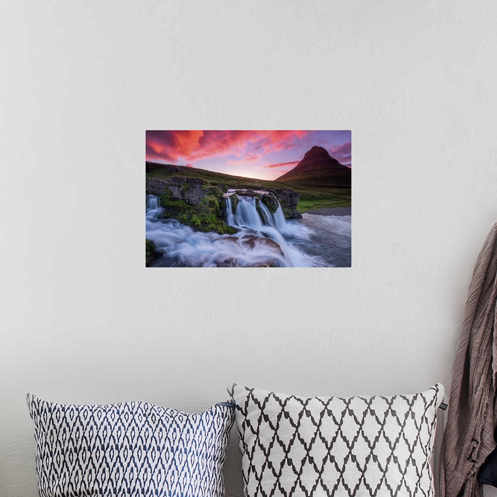 A bohemian room featuring Vivid light on clouds at dusk over a waterfall near Kirkjufell, Iceland.