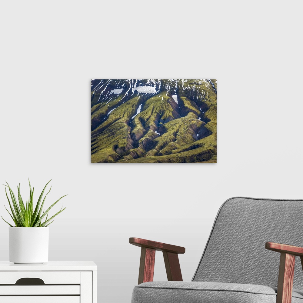 A modern room featuring Deep rifts in the mountain landscape formed by years of glacial erosion, seen in an aerial view o...