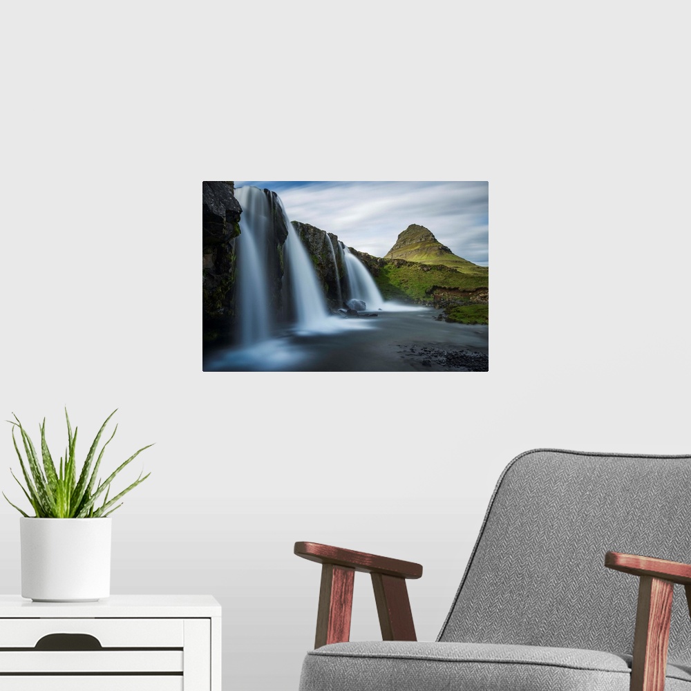 A modern room featuring Glacial waterfall in Iceland with a view of Kirkjufell mountain in the distance.