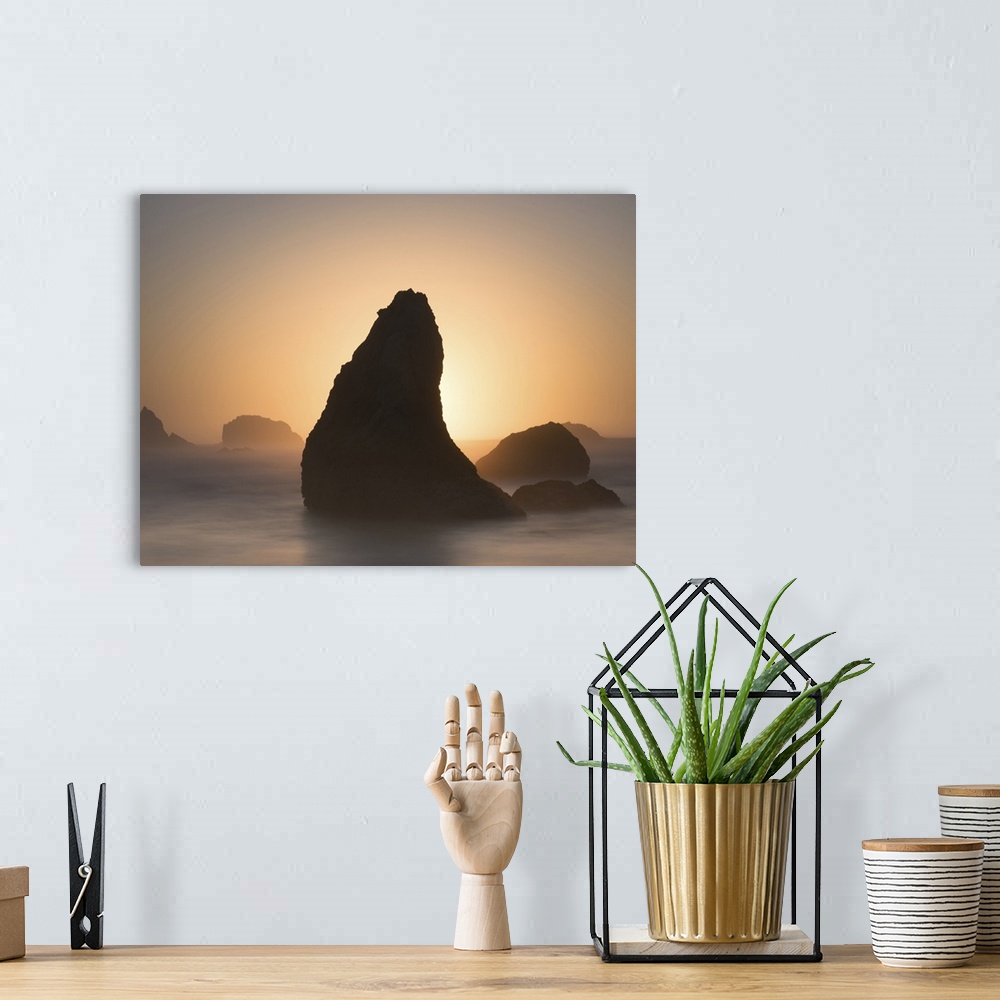 A bohemian room featuring Pointed sea stack in the misty ocean in the morning, Bandon, Oregon.