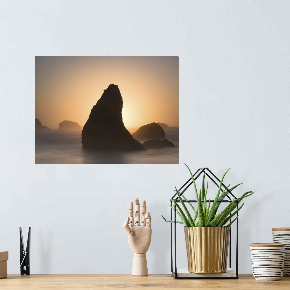 A bohemian room featuring Pointed sea stack in the misty ocean in the morning, Bandon, Oregon.