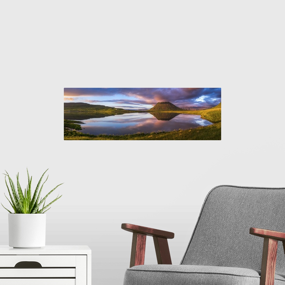 A modern room featuring Panoramic view of Mount Kirkjufell and the lake below at sunset, Iceland.