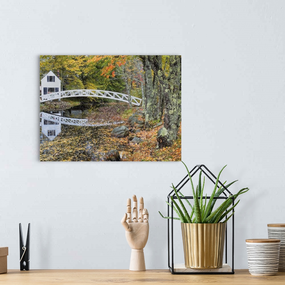 A bohemian room featuring A white wooden bridge arching over a stream in a forest in the fall, near mossy trees.