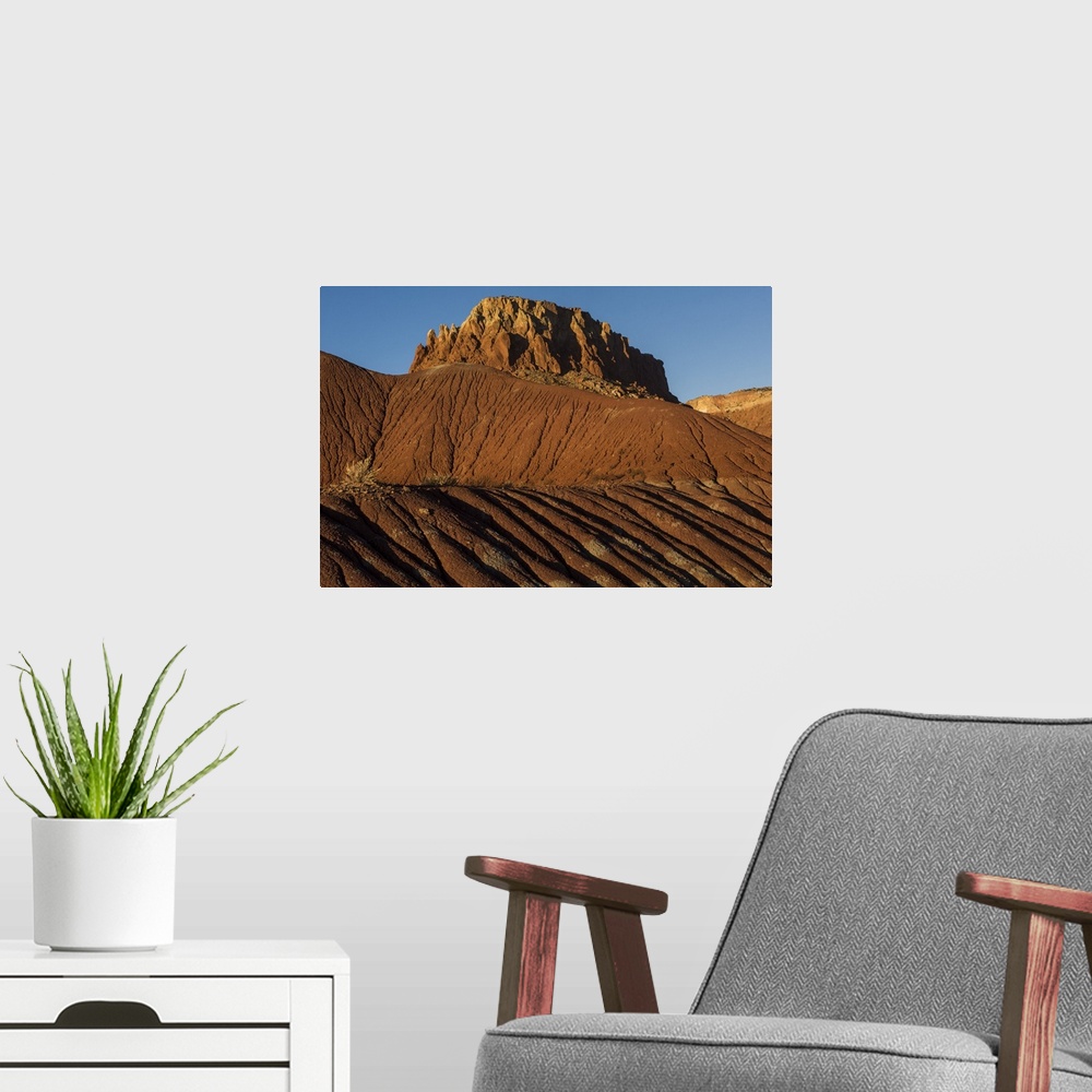 A modern room featuring Tall desert rocks just outside of Santa Fe, New Mexico, in the late afternoon.