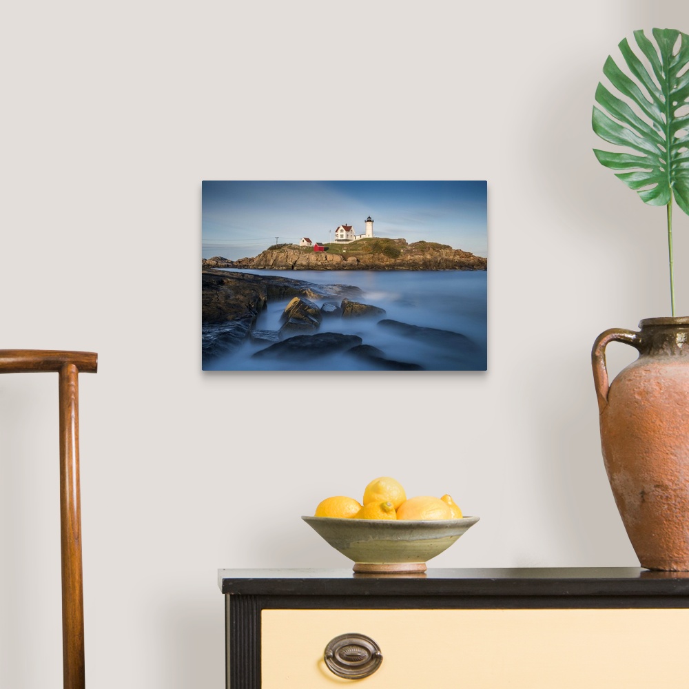 A traditional room featuring Nubble Lighthouse in Cape Neddick, Maine, on a rocky outcropping in the ocean on the rugged coast.
