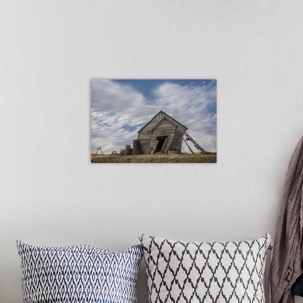 A bohemian room featuring Abandoned schoolhouse building leaning heavily to the side, against a backdrop of clouds, Palouse...