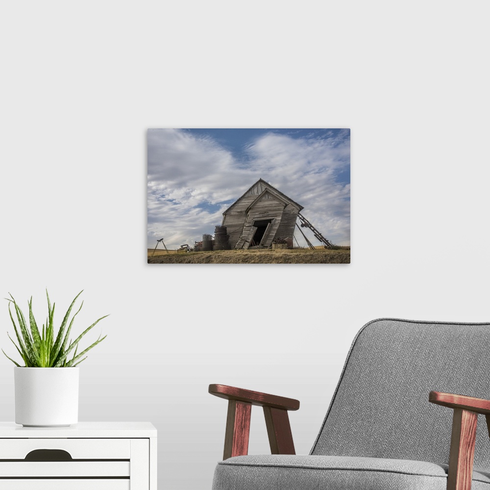 A modern room featuring Abandoned schoolhouse building leaning heavily to the side, against a backdrop of clouds, Palouse...