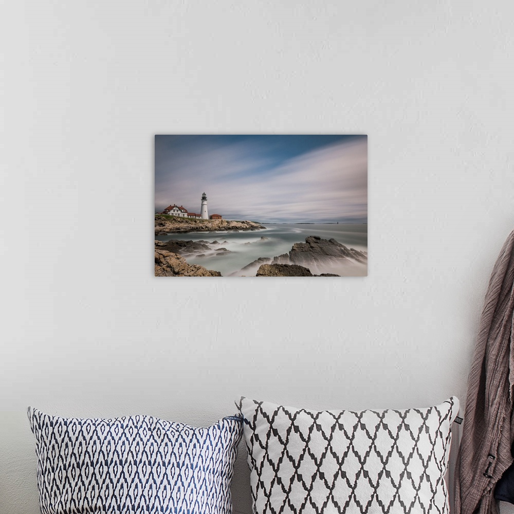 A bohemian room featuring Lighthouse on the rocky coast of Maine with sweeping clouds above.