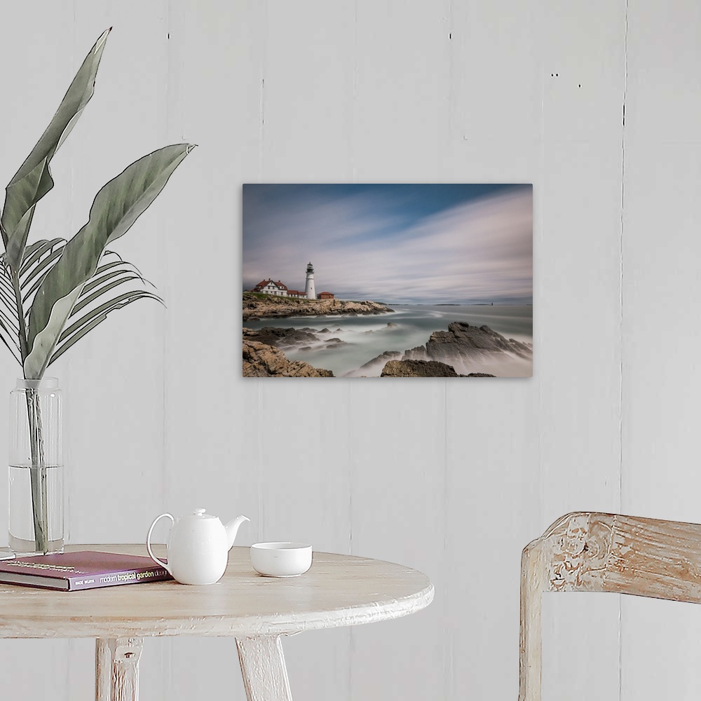 A farmhouse room featuring Lighthouse on the rocky coast of Maine with sweeping clouds above.