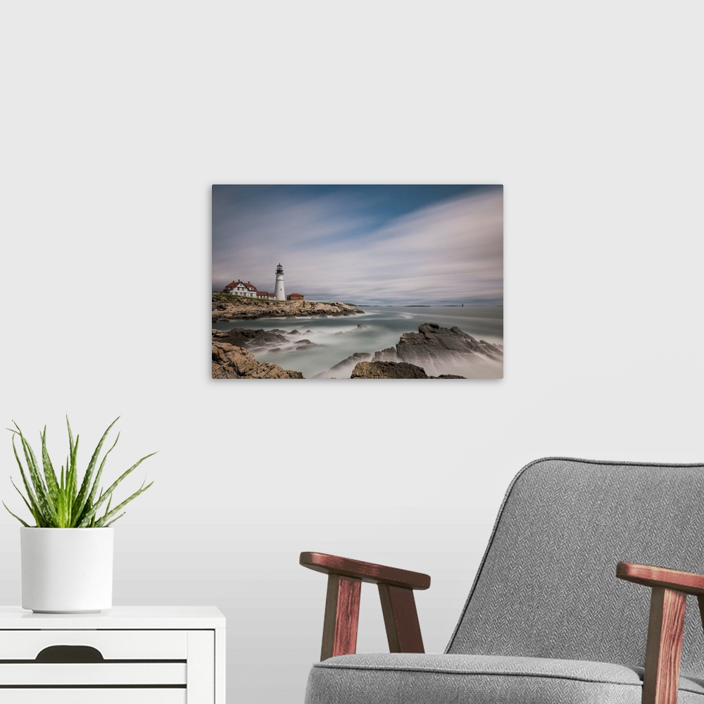 A modern room featuring Lighthouse on the rocky coast of Maine with sweeping clouds above.