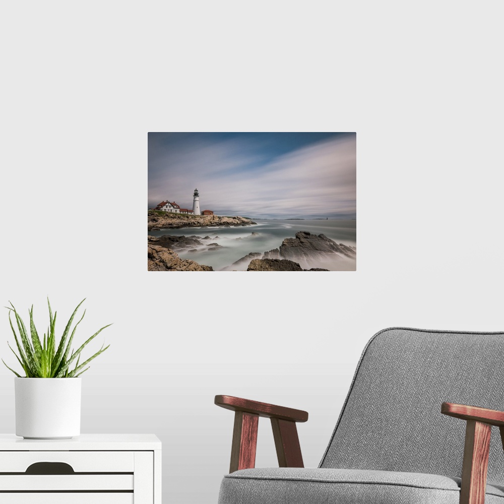 A modern room featuring Lighthouse on the rocky coast of Maine with sweeping clouds above.