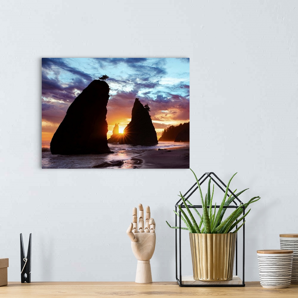 A bohemian room featuring Sea stacks silhouetted by the sunset light on the Washington coast.