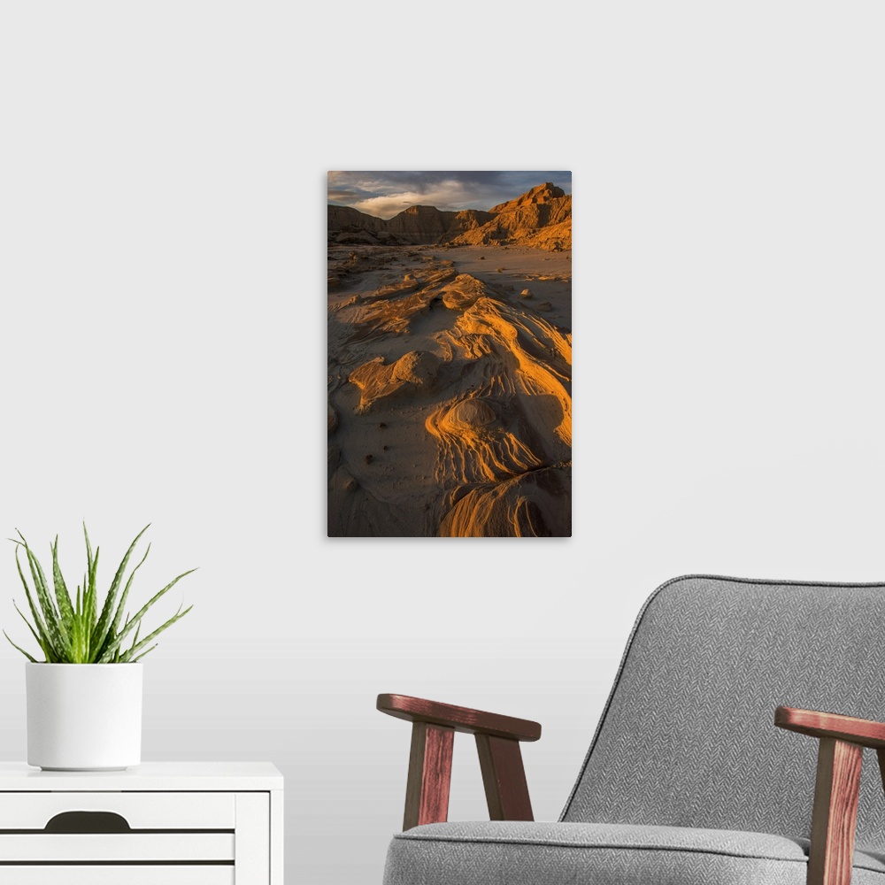 A modern room featuring Eroded rocks in the South Dakota Badlands in warm light from the sunset.