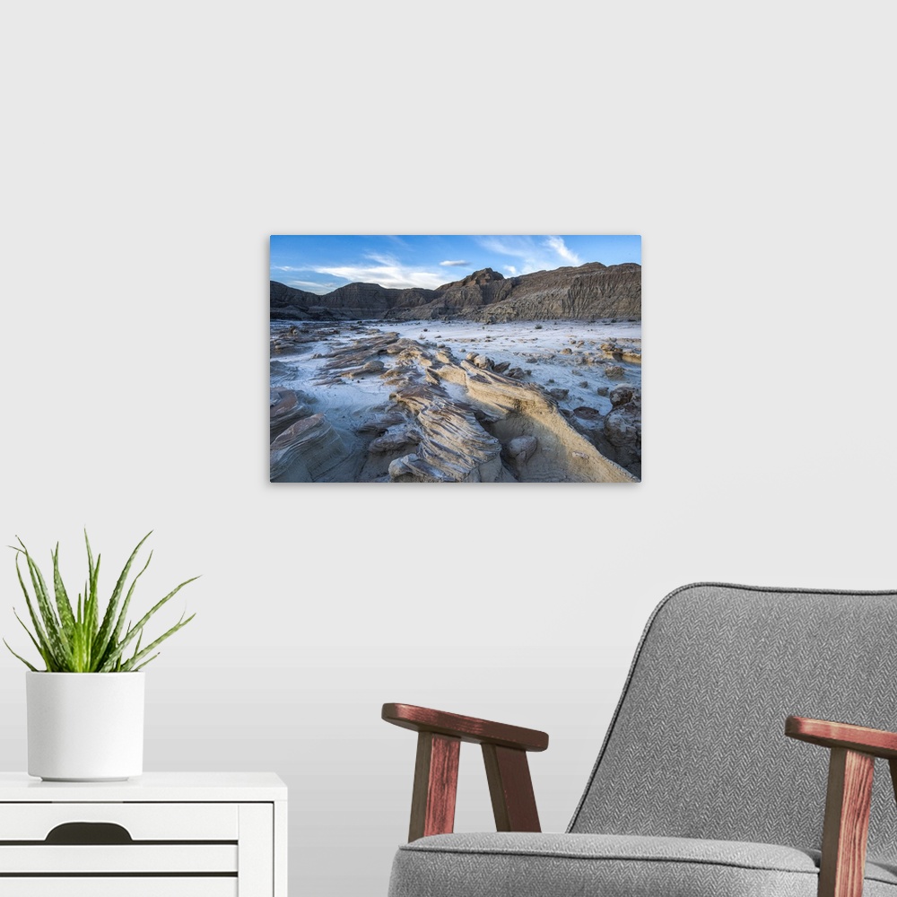 A modern room featuring Rocky lake bed surrounded by tall rock formations in Badlands National Park, South Dakota.