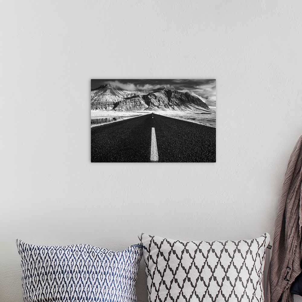 A bohemian room featuring A road leading to rugged mountains on the South Coast of Iceland.