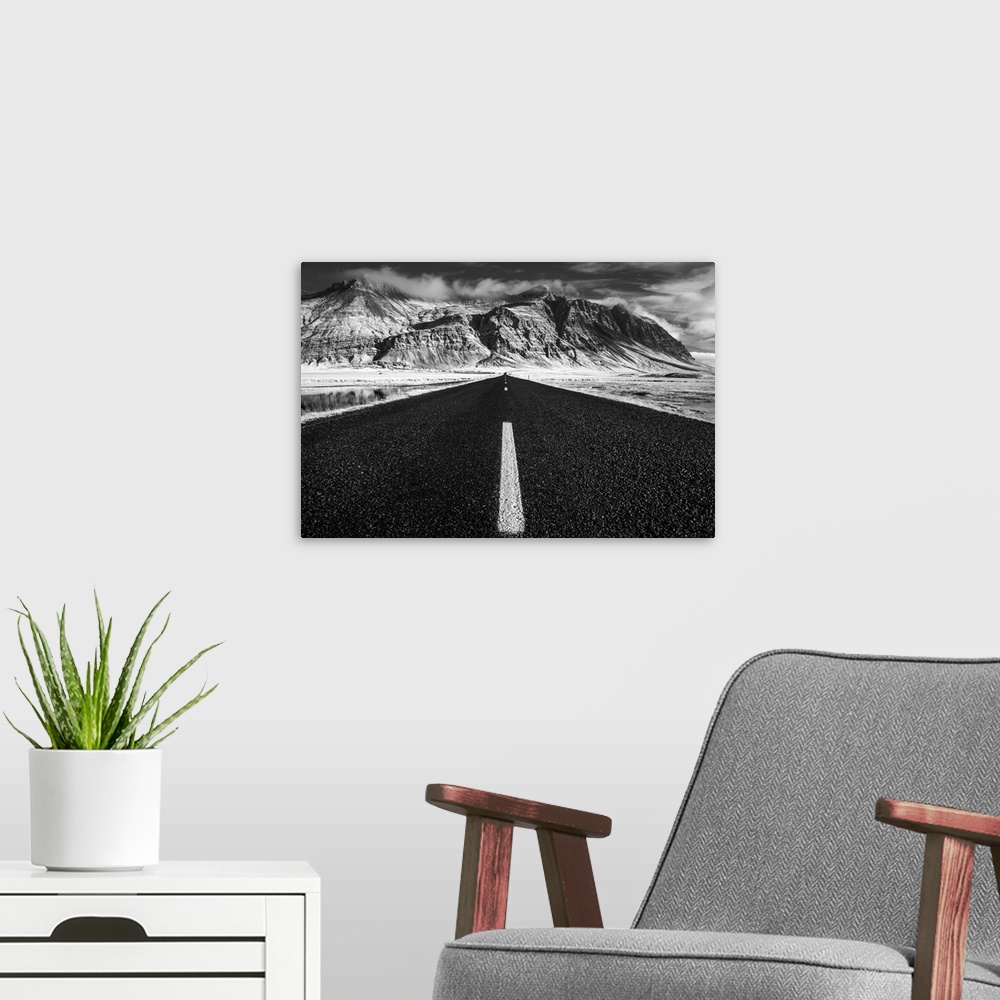 A modern room featuring A road leading to rugged mountains on the South Coast of Iceland.