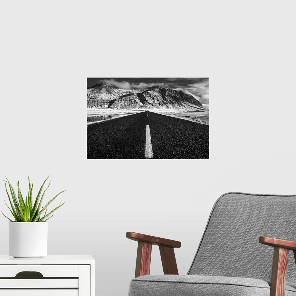 A modern room featuring A road leading to rugged mountains on the South Coast of Iceland.