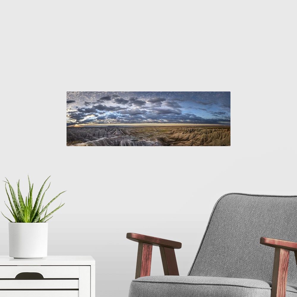 A modern room featuring Panoramic view of stunning clouds at sunset over the hilly terrain of the South Dakota Badlands.