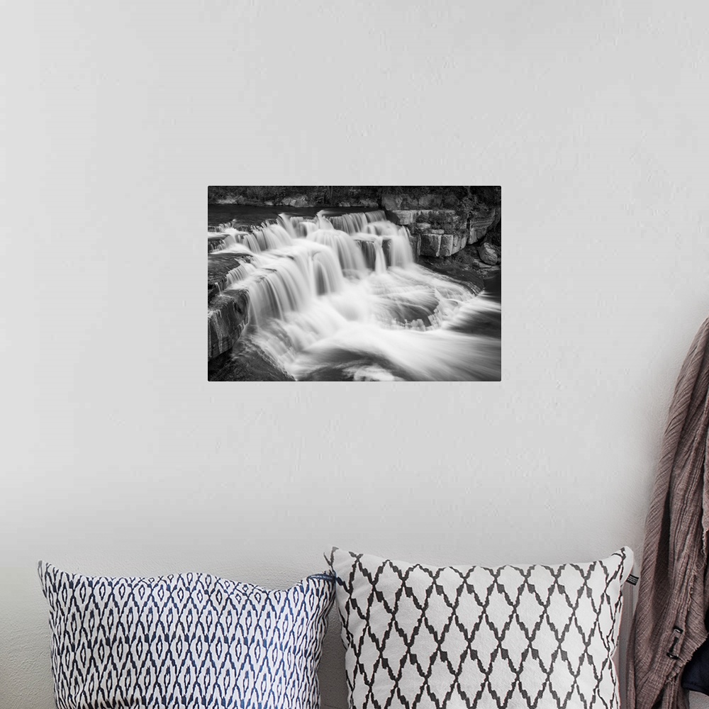 A bohemian room featuring Black and white image of a rushing waterfall in Ithaca, New York.