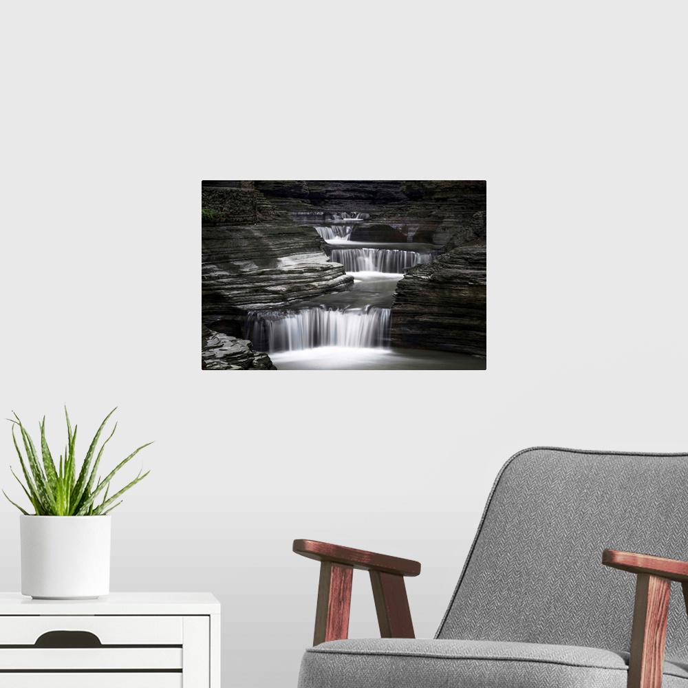 A modern room featuring Black and white image of a rushing waterfall in upstate New York.