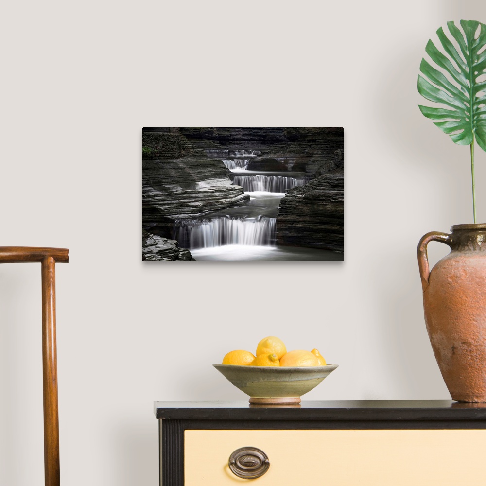 A traditional room featuring Black and white image of a rushing waterfall in upstate New York.