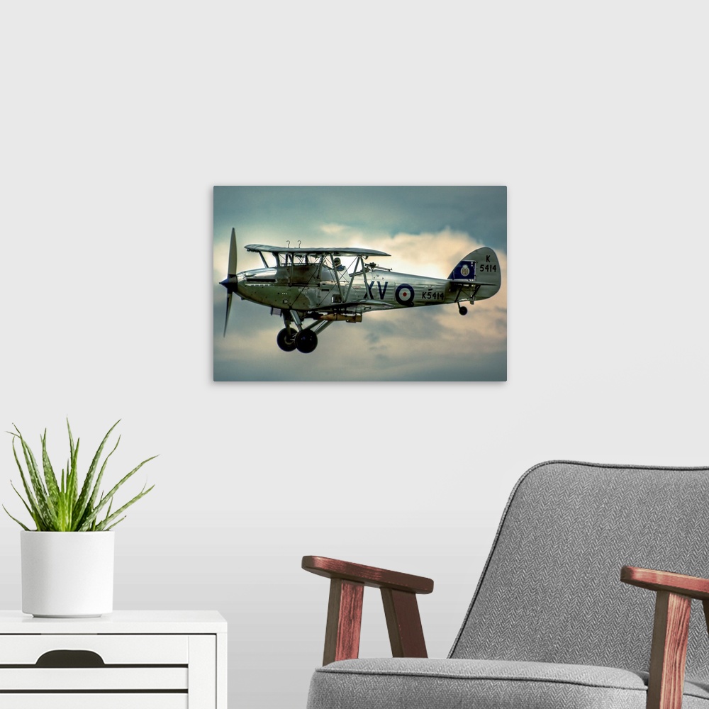 A modern room featuring A 1935 Hawker Hind flying on a cloudy day