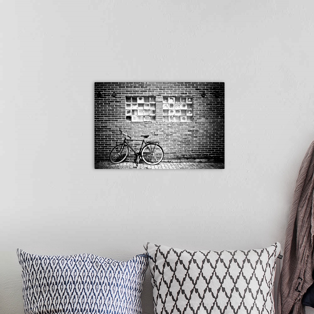 A bohemian room featuring A bicycle beside a brick wall