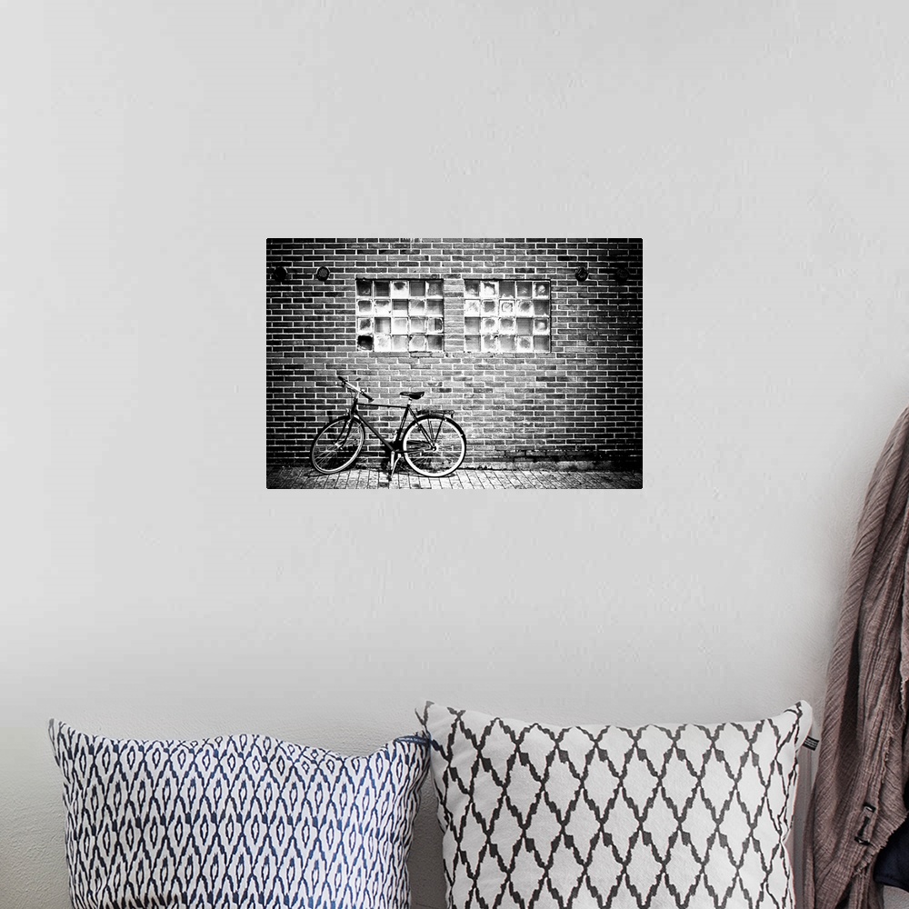 A bohemian room featuring A bicycle beside a brick wall