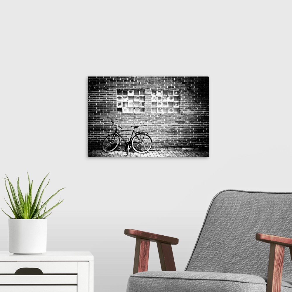 A modern room featuring A bicycle beside a brick wall
