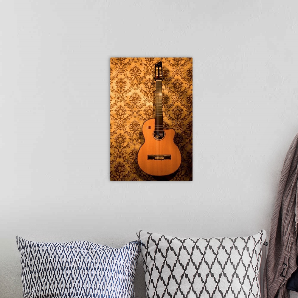 A bohemian room featuring A handmade acoustic guitar hangs on the wallpaper covered walls of a North Carolina guitar makers...