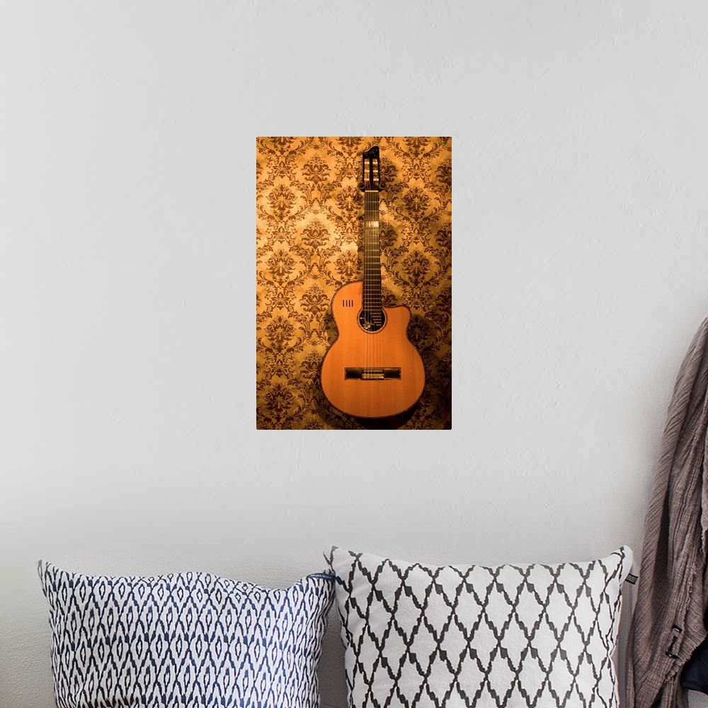A bohemian room featuring A handmade acoustic guitar hangs on the wallpaper covered walls of a North Carolina guitar makers...
