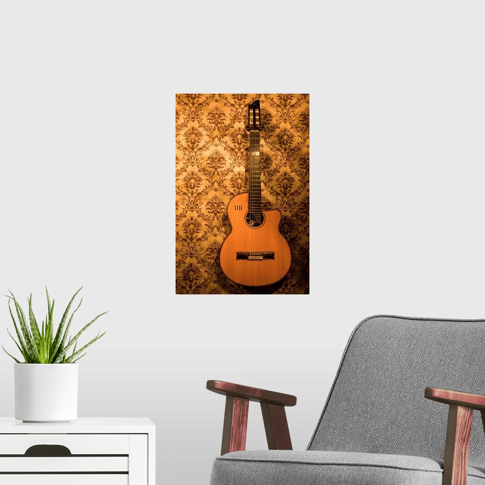A modern room featuring A handmade acoustic guitar hangs on the wallpaper covered walls of a North Carolina guitar makers...