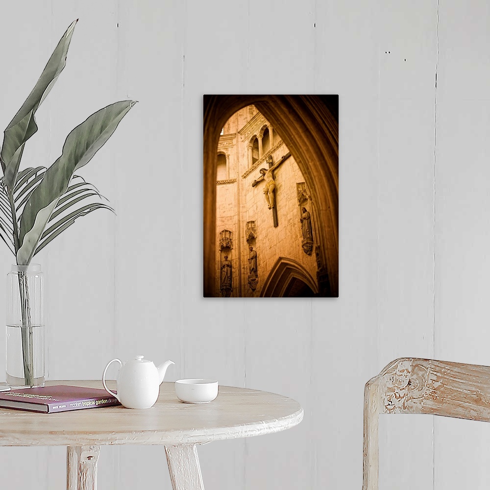A farmhouse room featuring A large crucifix hangs on the inside wall of a beautiful church in France