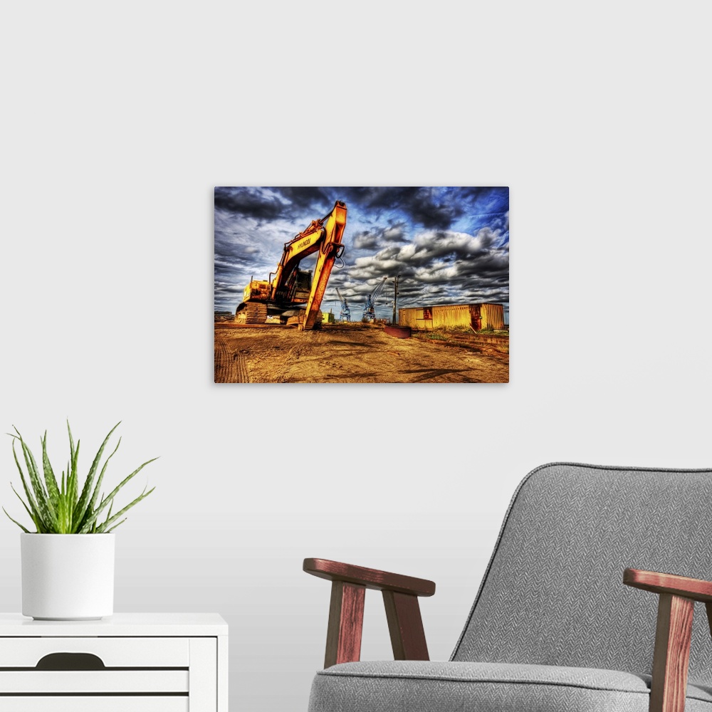 A modern room featuring A large yellow digger with caterpillar tracks on a building site with cranes in the distance and ...