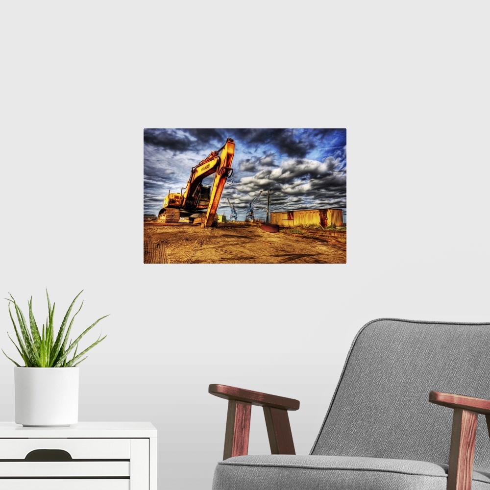 A modern room featuring A large yellow digger with caterpillar tracks on a building site with cranes in the distance and ...