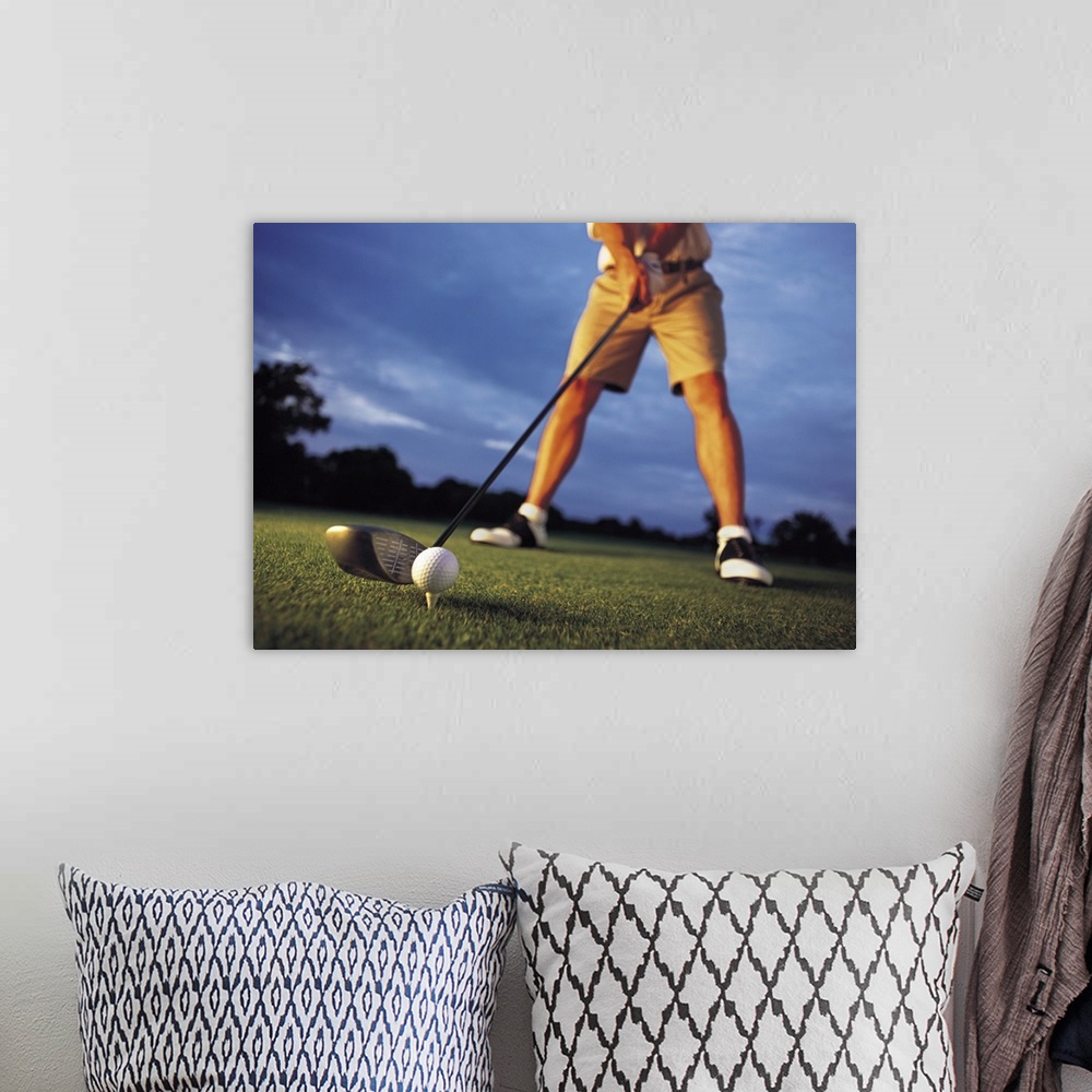 A bohemian room featuring A low angle shot of a golfer preparing to tee off at a golf course