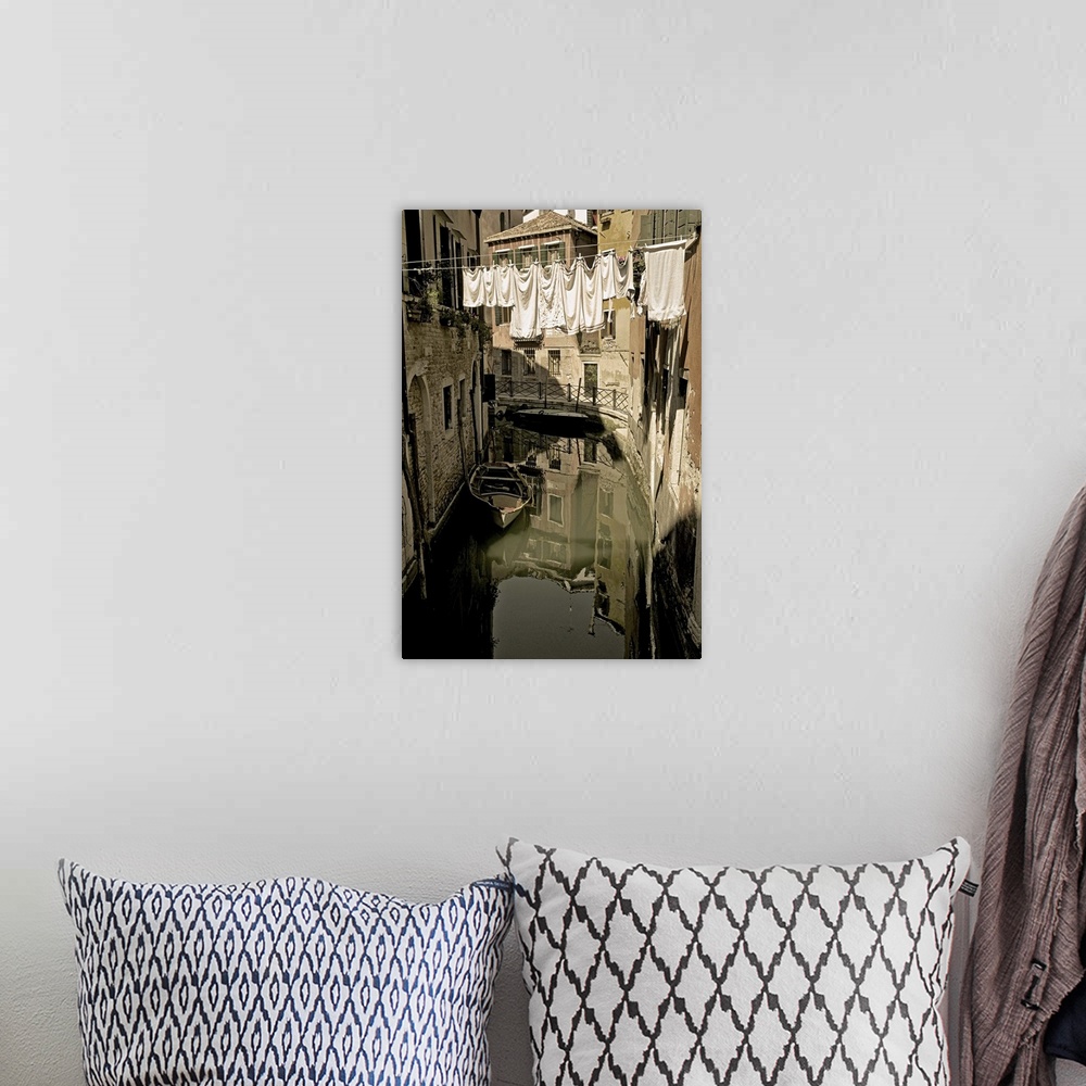 A bohemian room featuring Laundry drying on a clothesline, hanging over a canal in Venice, Italy.