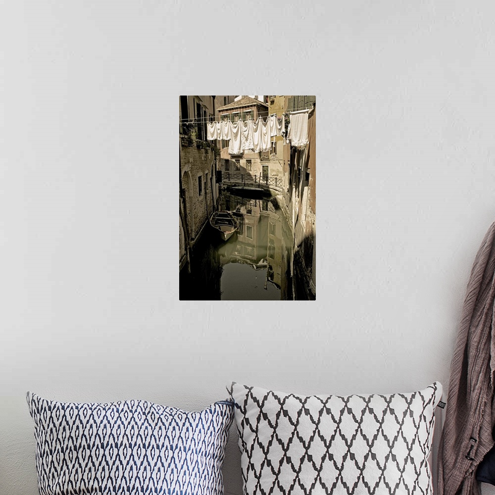A bohemian room featuring Laundry drying on a clothesline, hanging over a canal in Venice, Italy.