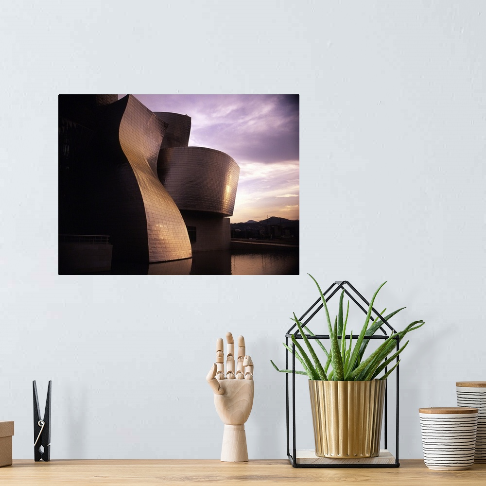 A bohemian room featuring An exterior shot of the architecture of the Guggenheim Museum in Bilbao, Spain