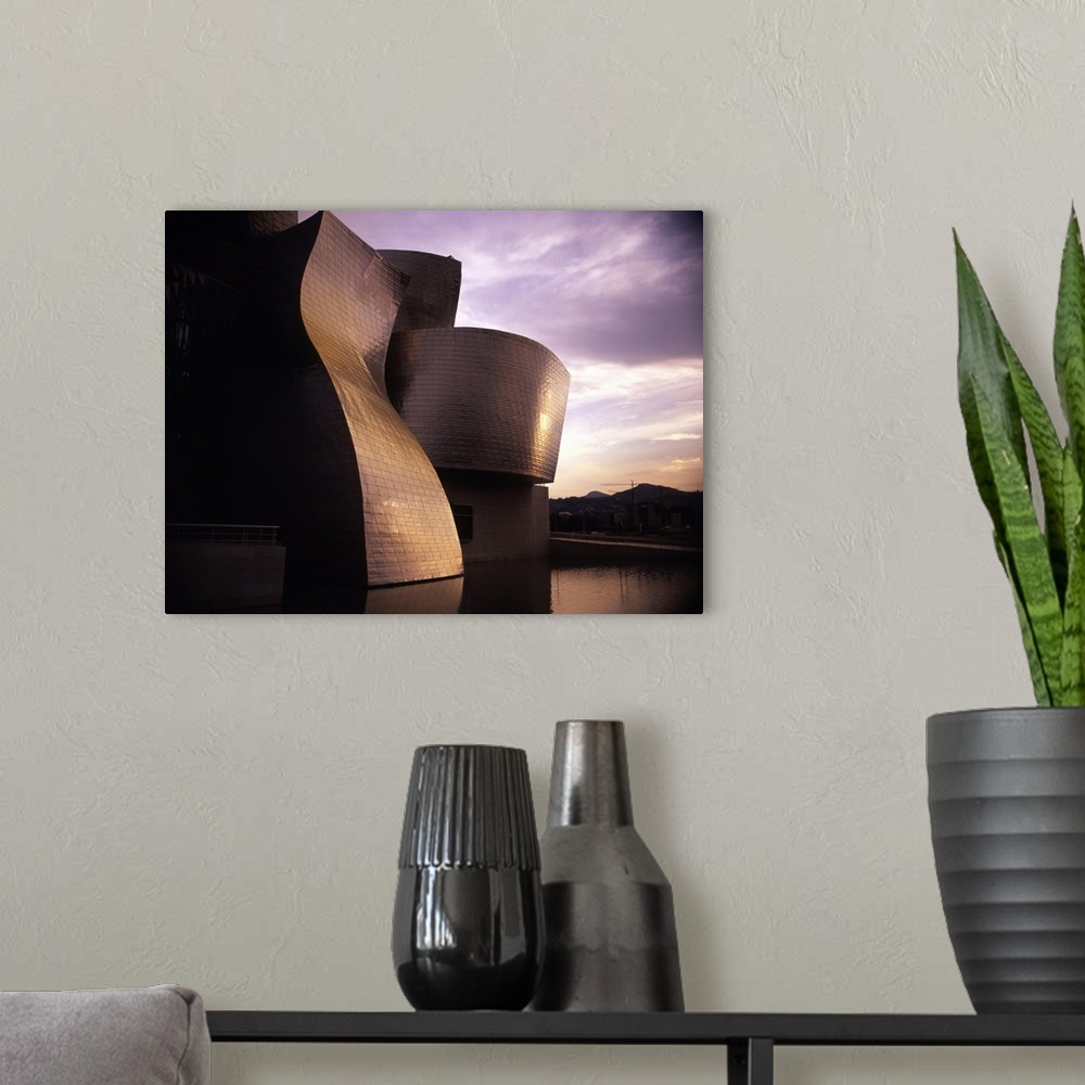 A modern room featuring An exterior shot of the architecture of the Guggenheim Museum in Bilbao, Spain