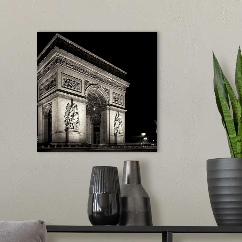 A modern room featuring Arc de Triomphe, Paris, France at night
