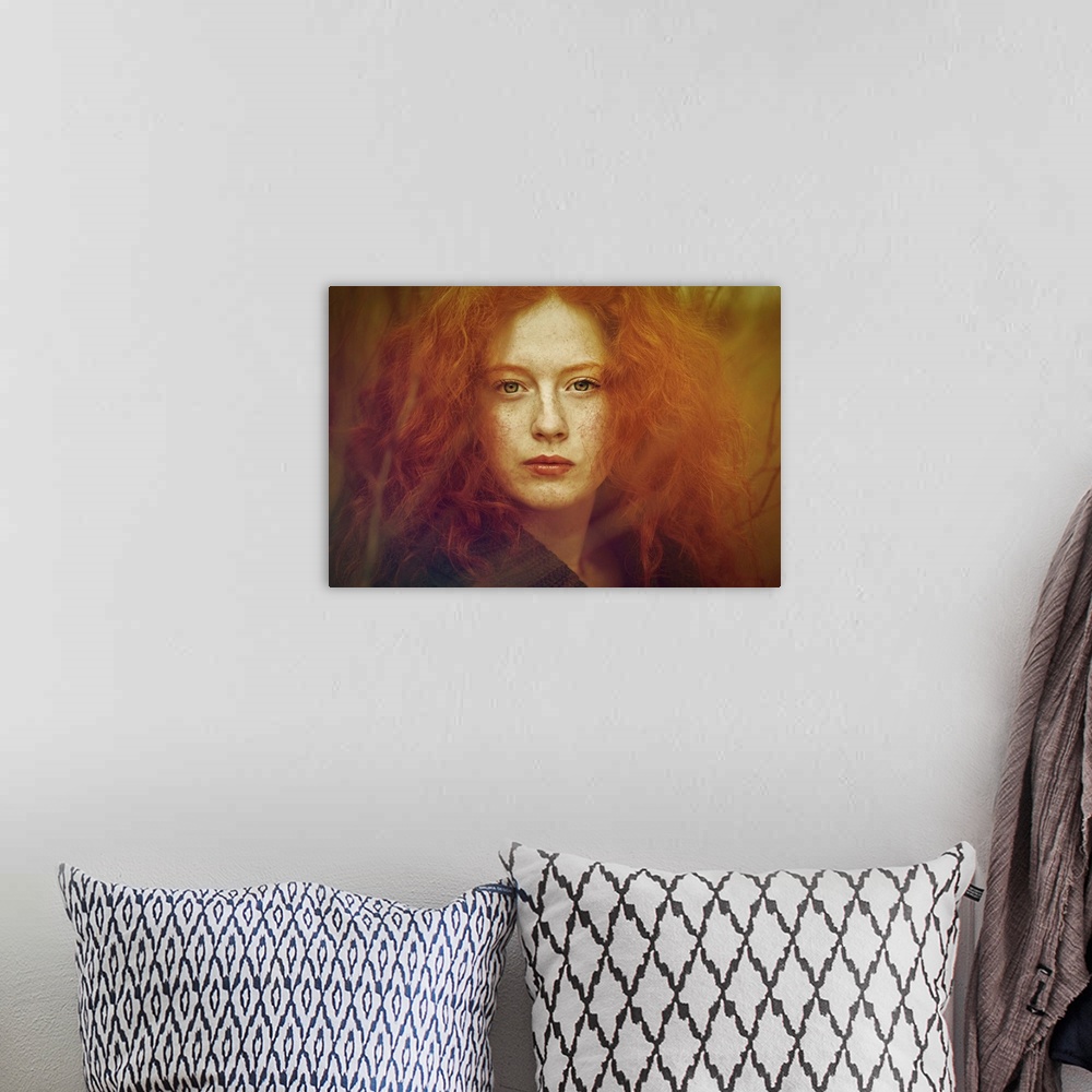 A bohemian room featuring Close-up portrait of female youth withfreckles, red curly hair and piercing green eyes.