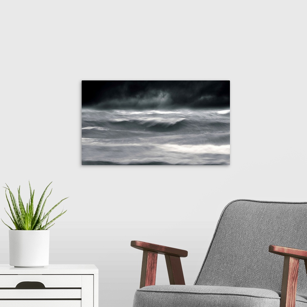 A modern room featuring Powerful waves in a seascape under a dark stormy sky