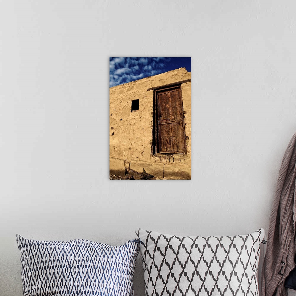 A bohemian room featuring Brown wooden door with blue sky and clouds, Karnak, Egypt