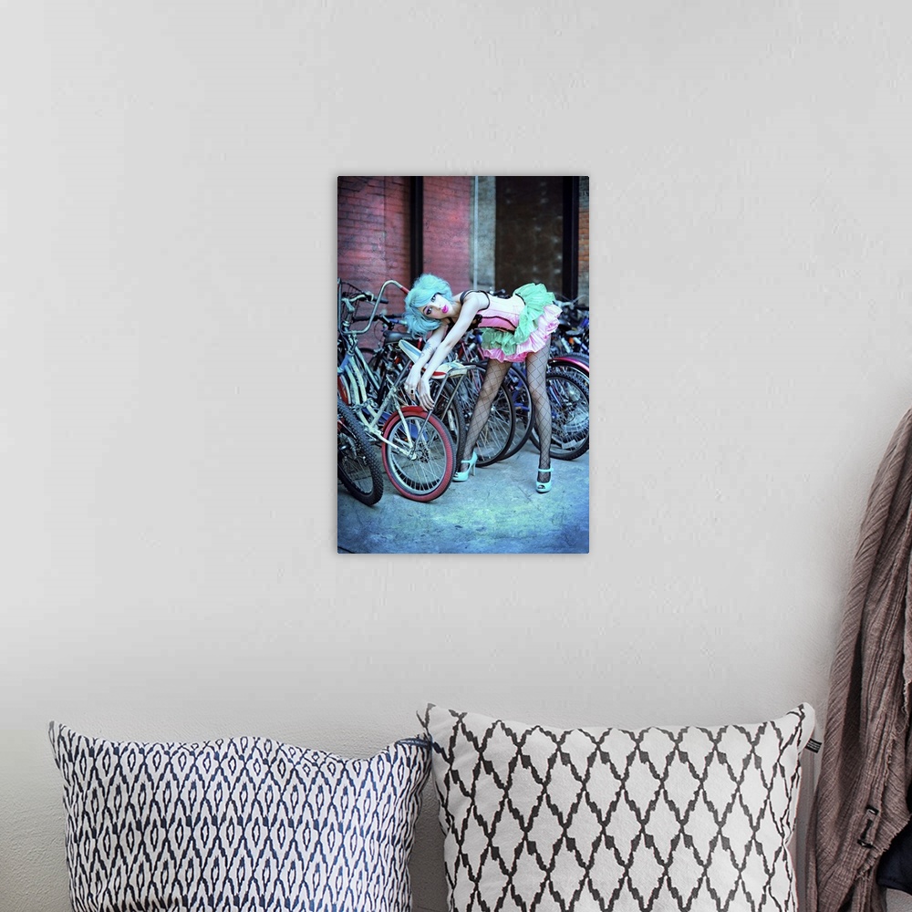 A bohemian room featuring A blue-haired model poses in a tutu against a rack of bikes with a surprised expression.