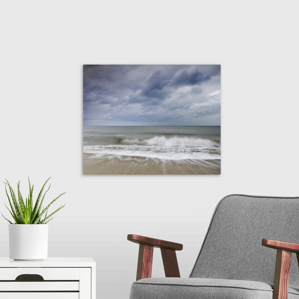 A modern room featuring Southbourne beach at sunset.