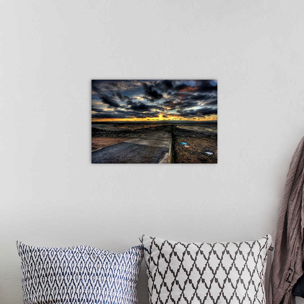 A bohemian room featuring Cloudy evening sunset over an estuary with dramatic stormy clouds looking out over a causeway wit...
