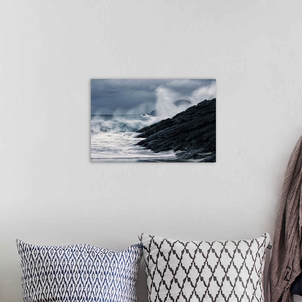 A bohemian room featuring Crashing waves on a stormy Scottish beach with dark rocks under grey sky