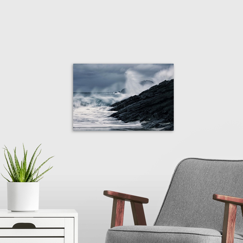 A modern room featuring Crashing waves on a stormy Scottish beach with dark rocks under grey sky